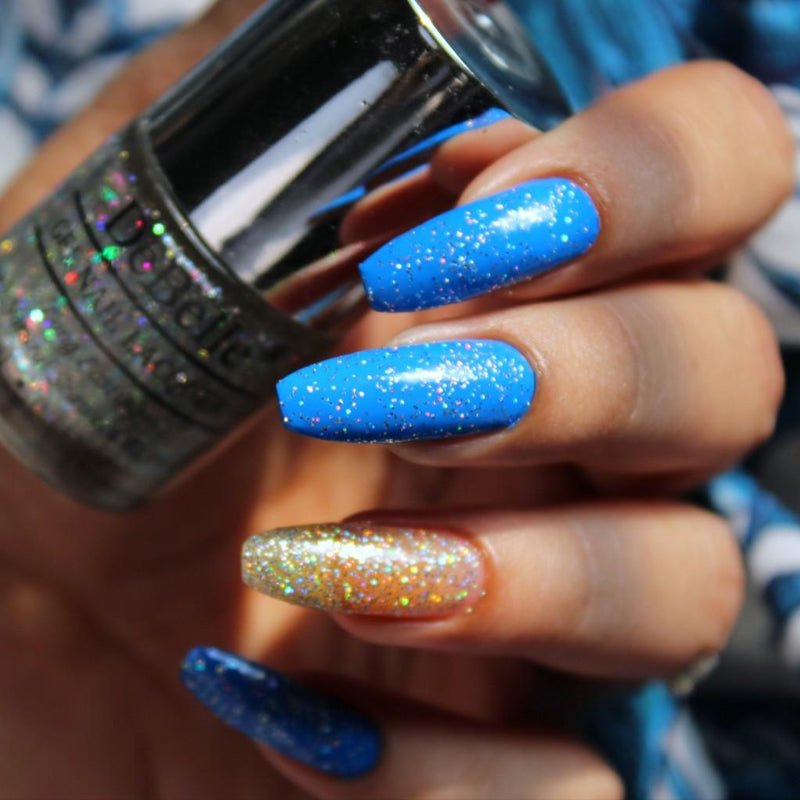 DeBelle's holographic_nail_polish_top_coat Bottle with the painted nails