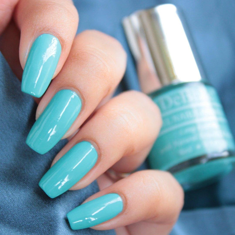 Thahiti Teal the blue DeBelle gel nail color . This alluring shade enriched with seaweed extract is available online at DeBelle Cosmetix online store.