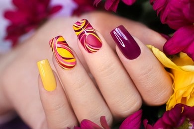 Nail design on shiny and matte nail Polish with smooth curves. Fashionable multicolored manicure.