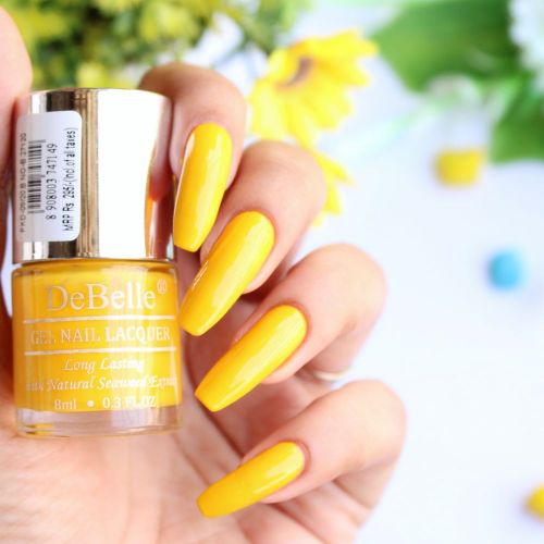 Smiling nails with DeBelle gel nail color Caramelo yellow the bright  yellow shade. Buy online at DeBelle Cosmetix online store.