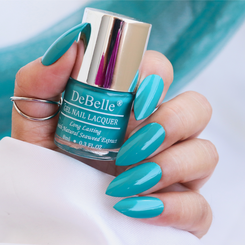 The turquoise blue at your nail tips with DeBelle gel nail color Royale Cocktail. Shop online for this shade enriched with hydrating seaweed extract  at Debelle Cosmetix online store.