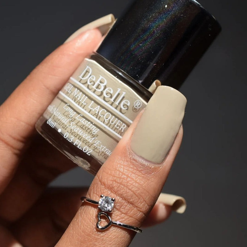 The new year is here. Start the change from the tip of your  nails.Paint your nails in this warm shade of Debelle Moonstone Bloom.This warm pastel dark grey with brown long lasting gel nail color is available on;ine with COD facility.