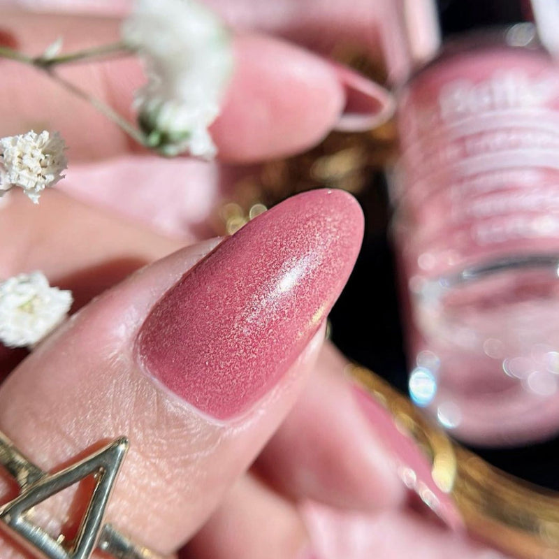 Close-up View of Nail painted from Debelle Mauve Nail polish with a blurry background 