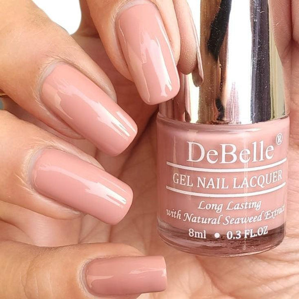 DeBelle Pink Mauve - Close-up view of the nail polish bottle and manicured nails 
