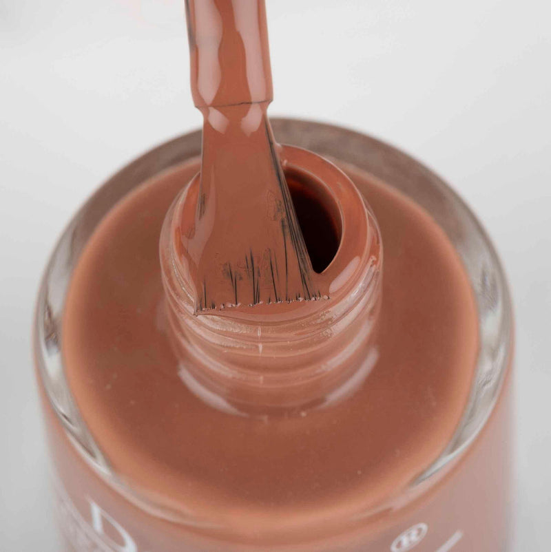 Close-in view of the opened bottle of DeBelle Rose Rust Bottle against a white background. 