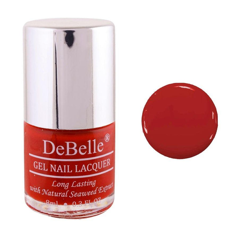 DeBelle Dark Red Nail Polish Front view of nail polish bottle with a white background and a coloured droplet 