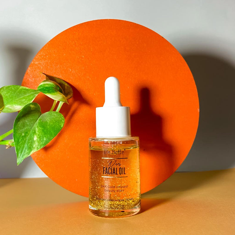 Front-view of Debelle facial oil placed Infront of orange circular circle against a cream background 