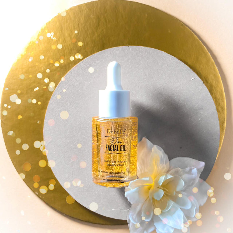 Debelle Golden Facial oil filled with oil placed against a white background with a golden circular ring.