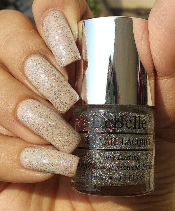 DeBelle Gel Nail Shimmer Top Coat- Close-up view of the nail polish bottle and painted nails 