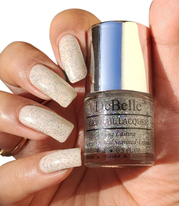 DeBelle Shimmer Top Coat- Close-up view of the nail polish bottle and painted nails against a white background