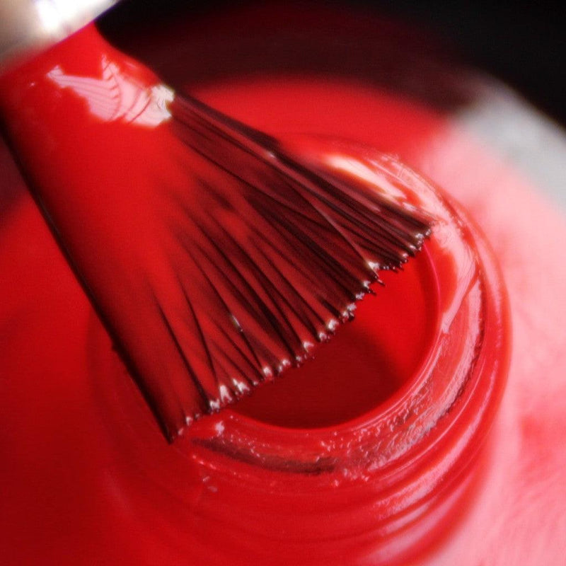 DeBelle Scarlet Red Nail Polish - Close-up view of the nail polish brush with the bottle 