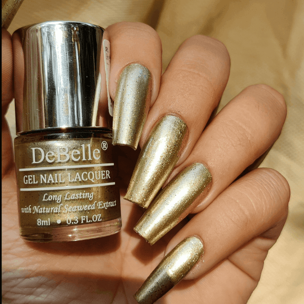 The killing looks with DeBelle gel nail color Canopus the  beige gold with black glitter shade. Shop online from the comfort of  your home at DeBelle Cosmetix online store. g