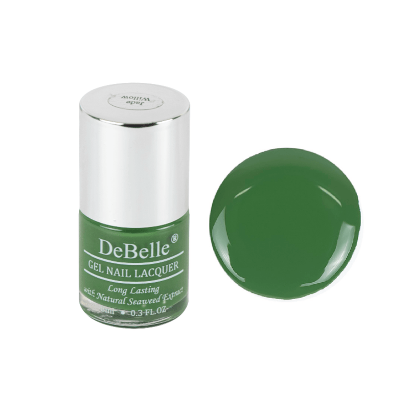 DeBelle olive green Nail polish bottle against a white background with a droplet of the same shade.
