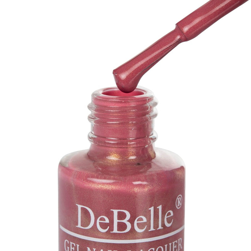 Opened bottle of Debelle Shimmer Dark Mauve with the Nail Brush has White background 