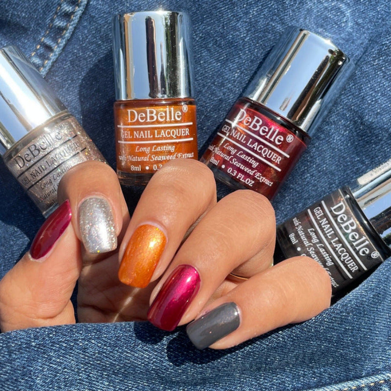 Collection of Four Nail Polish which are Sparkling,Dust Aurora ,Antares & Copper Glaze from DeBelle with Jeans as the background